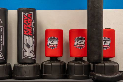 K3 Martial Arts training floor with Krav Maga heavy bags lined against the wall in Roseville