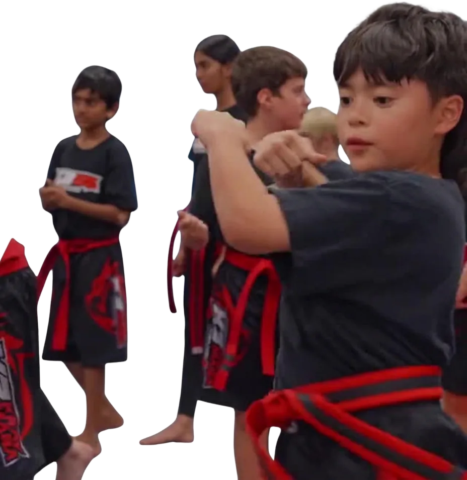 A row of kids in K3 uniforms holding their guard during class