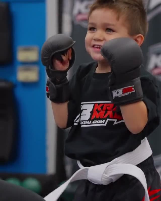Preschooler in a white belt and gloves holding a guard during a Lil' Dragons class at K3 Martial Arts in Roseville